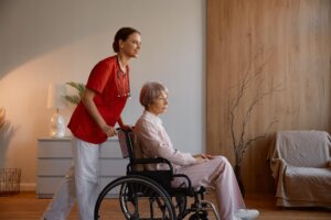 woman caregiver preparing elderly lady in wheelcha 2024 12 05 07 27 25 utc